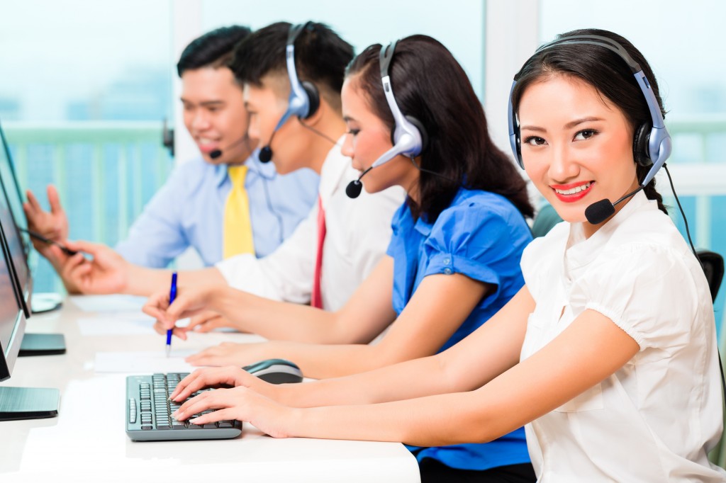 Asian Chinese call center agent team on phone